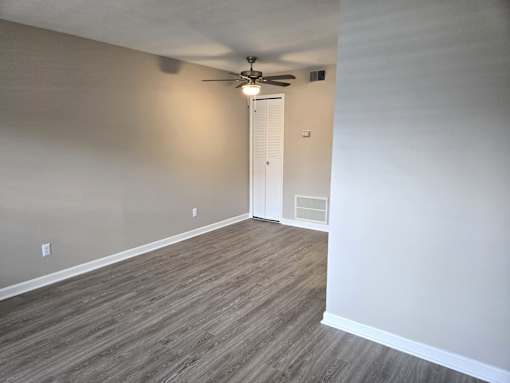 A room with a ceiling fan and light fixture.