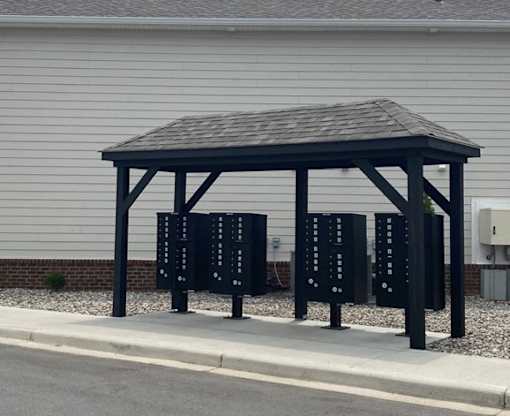 A mailbox shelter with a roof.