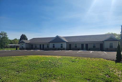 A large building with a parking lot in front of it.