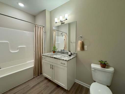 A white toilet sits next to a sink in a bathroom.