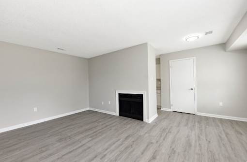 A room with a fireplace and a door on the right side.