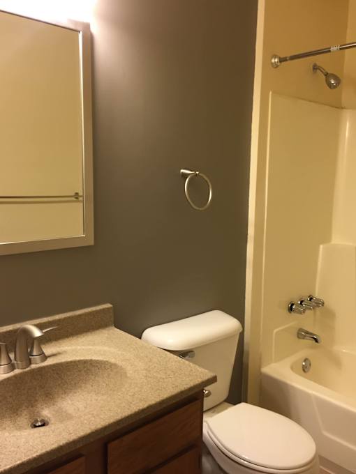 a small bathroom with a sink toilet and shower