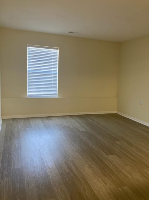 an empty bedroom with a window