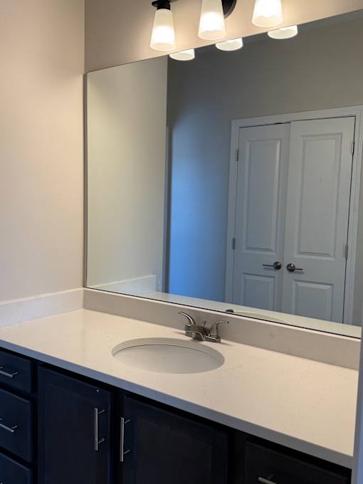A bathroom with a sink and mirror.