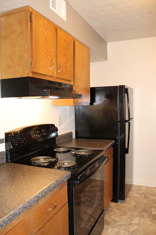 a kitchen with a stove and a refrigerator