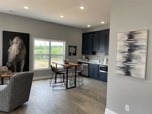 A modern kitchen with a dining table and chairs.