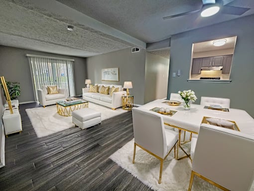 A dining room with a white table and chairs.