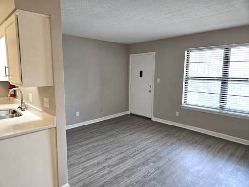 A room with a sink and a door.