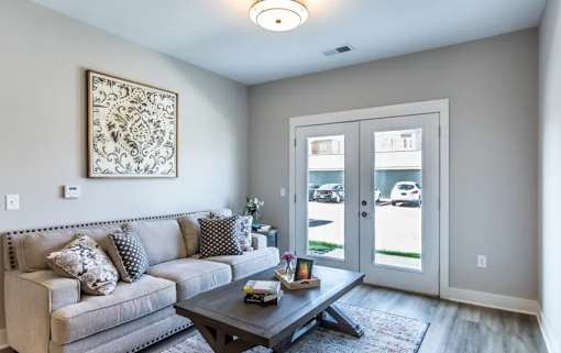 A living room with a grey couch and a coffee table.