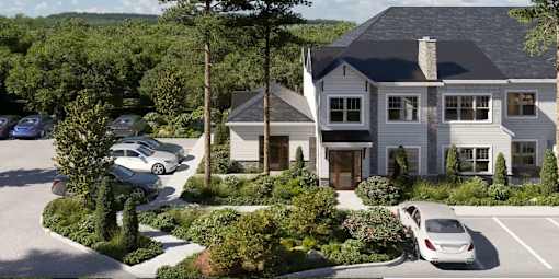 A large house with a grey roof and a car parked in front.