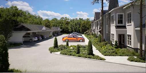 A car is parked on a driveway in front of a house.