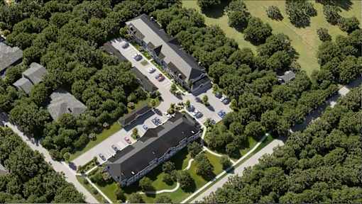 An aerial view of a building surrounded by trees.