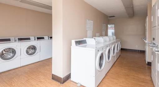 A row of washing machines in a laundromat.