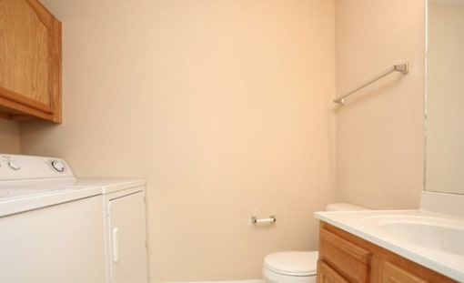 A small bathroom with a washer and dryer.