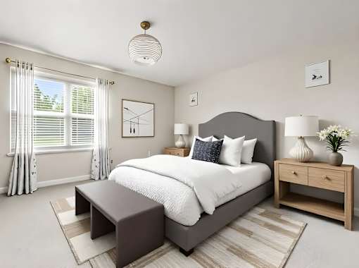 A bedroom with a large bed, a nightstand, and a window with curtains.