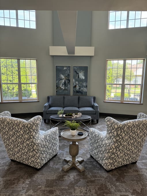 a view from above of a living room with couches and a table and windows