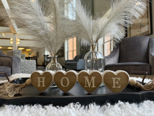 a coffee table with hearts and a sign that reads home