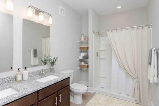A bathroom with a white shower curtain and a white toilet.
