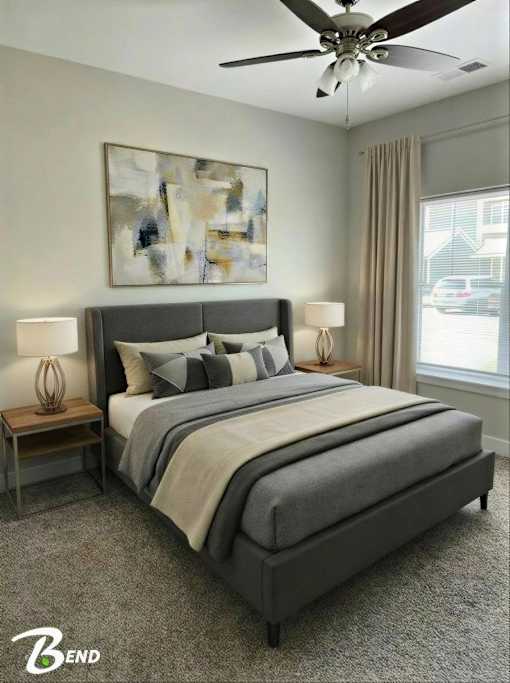 A bedroom with a large bed and a ceiling fan.