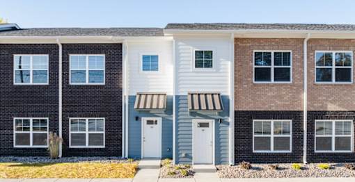 A row of townhouses with different colored exteriors.