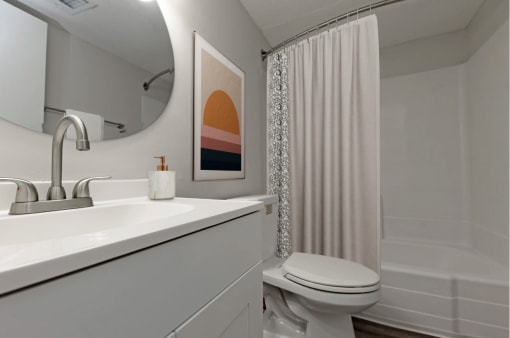 a bathroom with a shower and a sink and a toilet