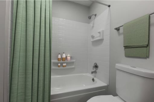 a bathroom with a shower curtain and a toilet and a sink