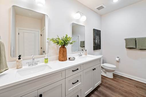 A bathroom with a white countertop and a white toilet.