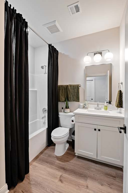 A bathroom with a white toilet, a white sink, and a white cabinet.