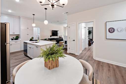 A modern kitchen with a dining table and chairs.