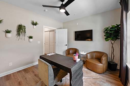 A living room with a brown leather chair and a wooden table.