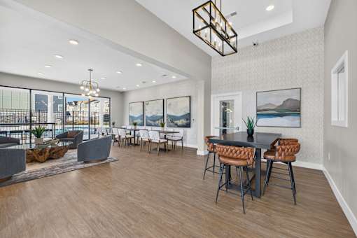 A modern dining room with a large table and chairs.