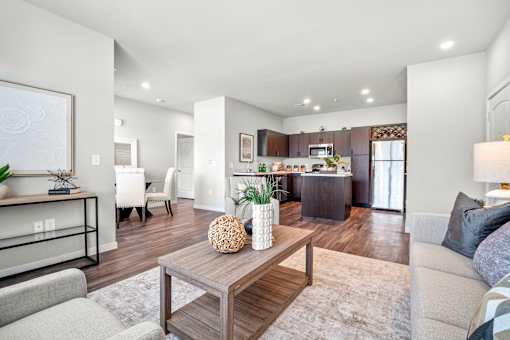 A modern living room with a wooden coffee table and grey couch.