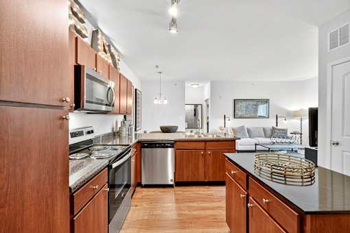 A modern kitchen with wooden cabinets and stainless steel appliances.