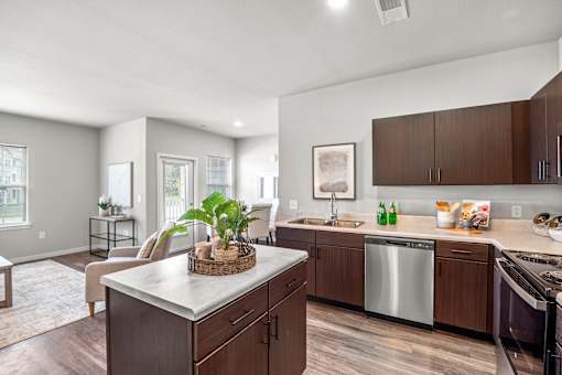 A kitchen with a stainless steel dishwasher and a sink.