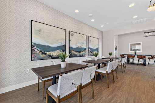 A dining room with a long table and chairs.