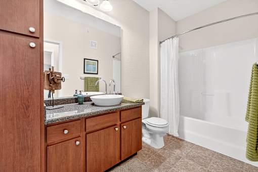 A bathroom with a sink, toilet, and bathtub.