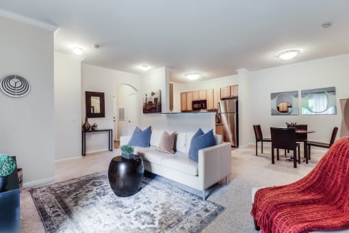 a living room with a white couch and a red chair at Plantation Crossing, Lafayette, LA, 70508