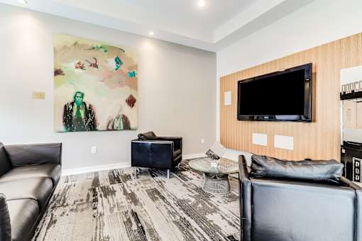 A living room with a large painting on the wall and a flat screen TV, Plantation Crossing, Lafayette, LA, 70508