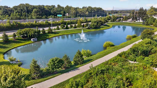 A large pond with a fountain in the middle of it.