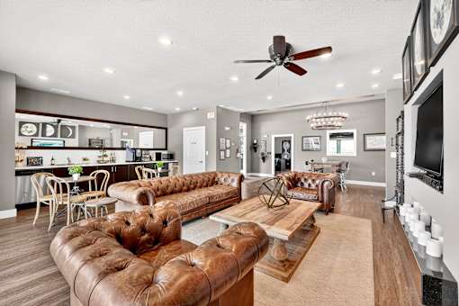 A living room with brown leather sofas and a wooden coffee table.