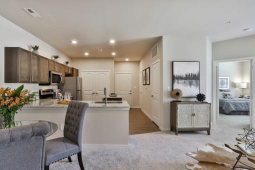 an open kitchen and living room with a couch and a table  at Aventura at Hawk Ridge, Lake St Louis, 63367