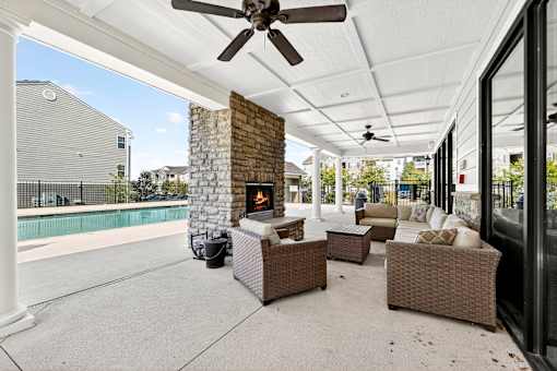A patio with a fireplace and furniture.