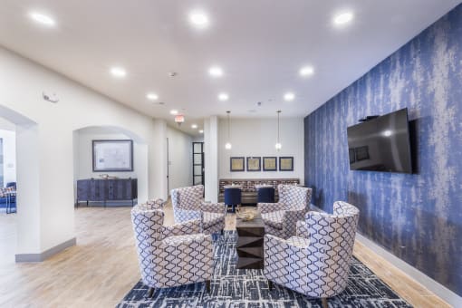 a living room with couches and a table and a television at Aventura at Wild Horse Creek, Chesterfield, Missouri