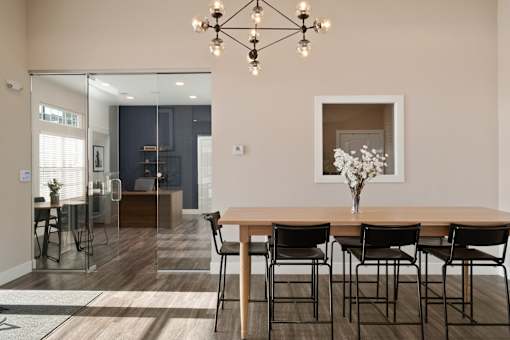 A dining room with a wooden table and chairs at Aventura at Wentzville I & II Apartments, Missouri, 63385
