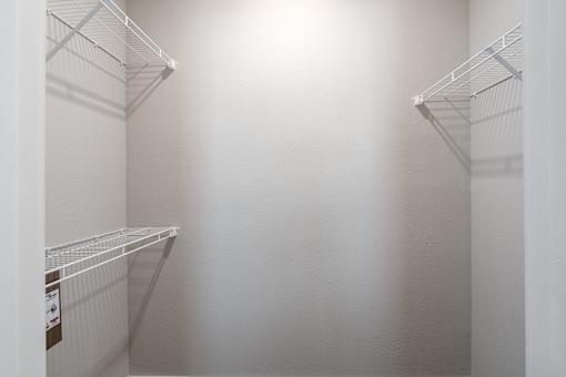 Empty white shelves in a room at Aventura at Wentzville I & II Apartments, Wentzville
