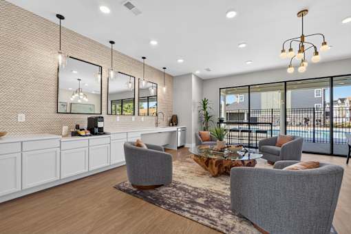 A modern living room with a grey sofa, a wooden coffee table, and a large window overlooking the city.
