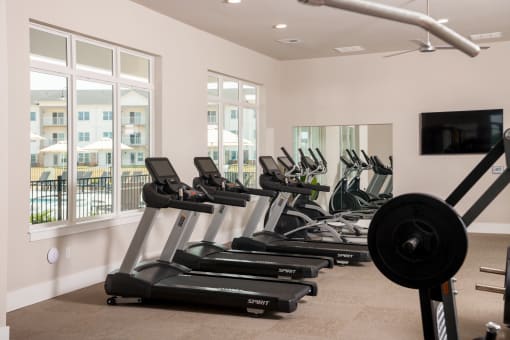 a row of treadmills and exercise machines in a fitness room  at The Edison at Madison, Madison, Alabama