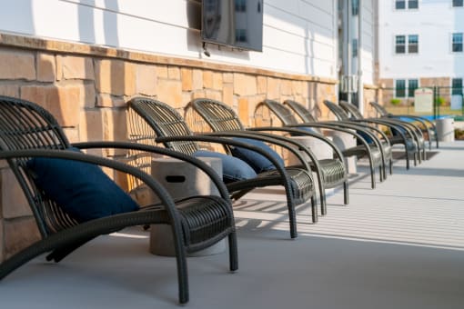 a row of chairs sit outside of a building  at The Edison at Madison, Alabama, 35757