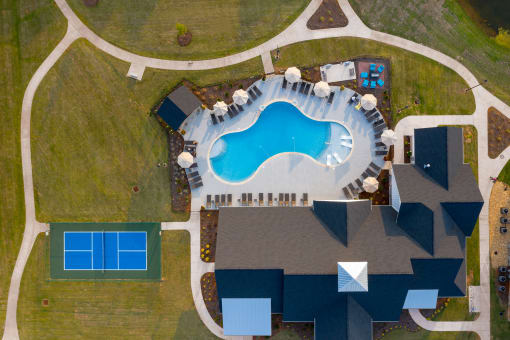 arial view of an outdoor swimming pool with umbrellas and a house  at The Edison at Madison, Alabama, 35757