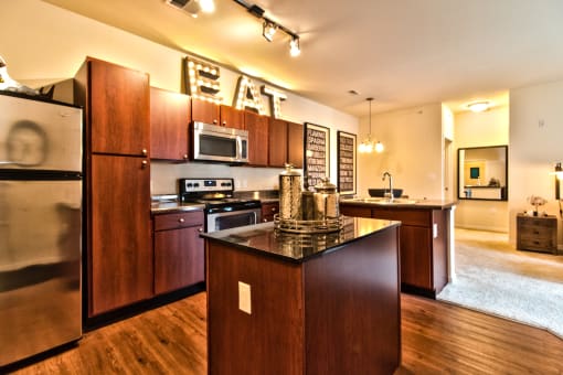 a kitchen with stainless steel appliances and an eat in counter top  at Aventura at Mid Rivers, St. Charles, 63304